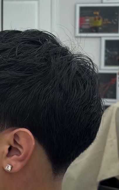 Low taper on the side with a clean line around the ear