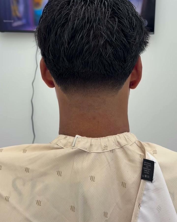 Back view of a mid taper with textured hair on top
